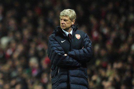 Arsene Wenger watches from the touchline during his side's 3-1 loss in the UEFA Champions League on February 19, 2013